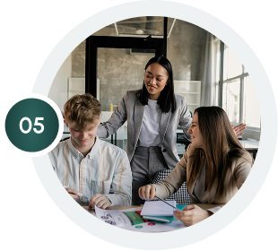 Team collaboration in office: Young professionals work together on a project, discussing business strategy and ideas for updated homepage.