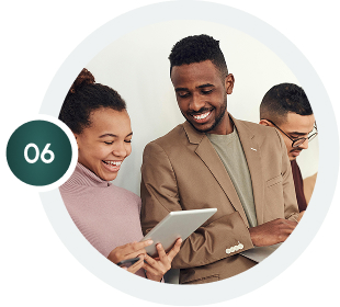 Homepage updated image: Diverse team smiling and using tablet. Happy office workers collaborate on a digital device. #updatedhomepage