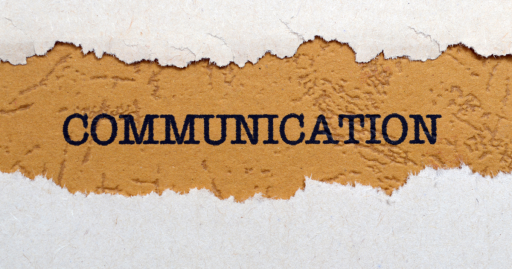 Torn orange paper revealing the word COMMUNICATION printed in bold navy letters.